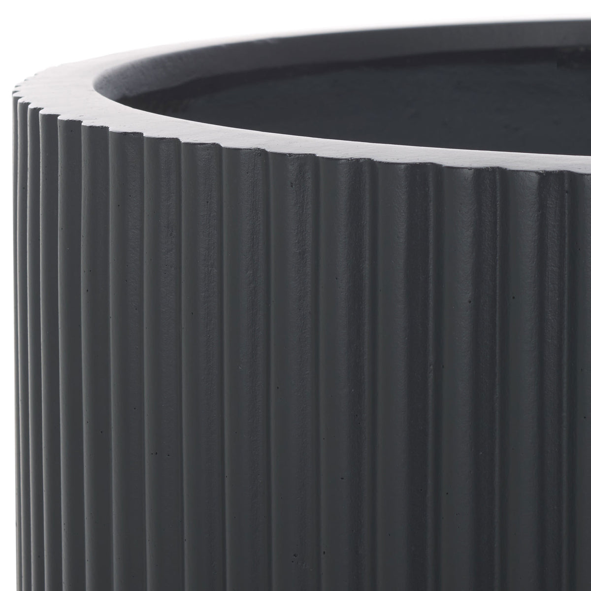 Deep black ribbing sits beneath a substantial rim, lending the planter a tailored texture. || PAT1533A || detail_studio