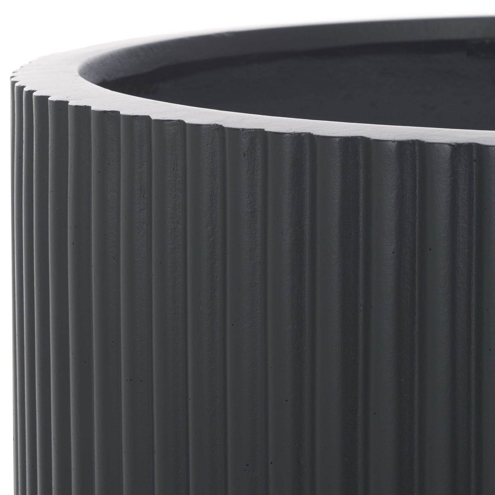 Deep black ribbing sits beneath a substantial rim, lending the planter a tailored texture. || PAT1533A || detail_studio