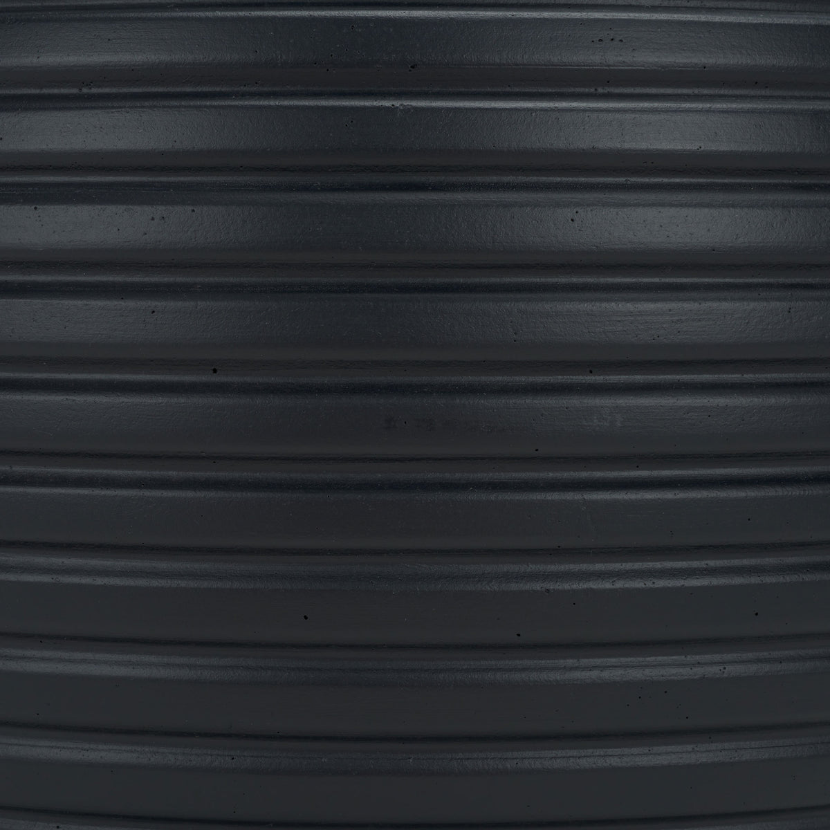 Deep black surface reveals subtle speckles and closely spaced raised bands. || PAT1534A || swatch_studio