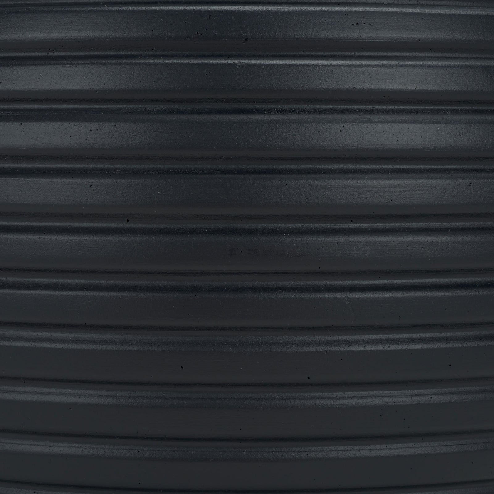 Deep black surface reveals subtle speckles and closely spaced raised bands. || PAT1534A || swatch_studio