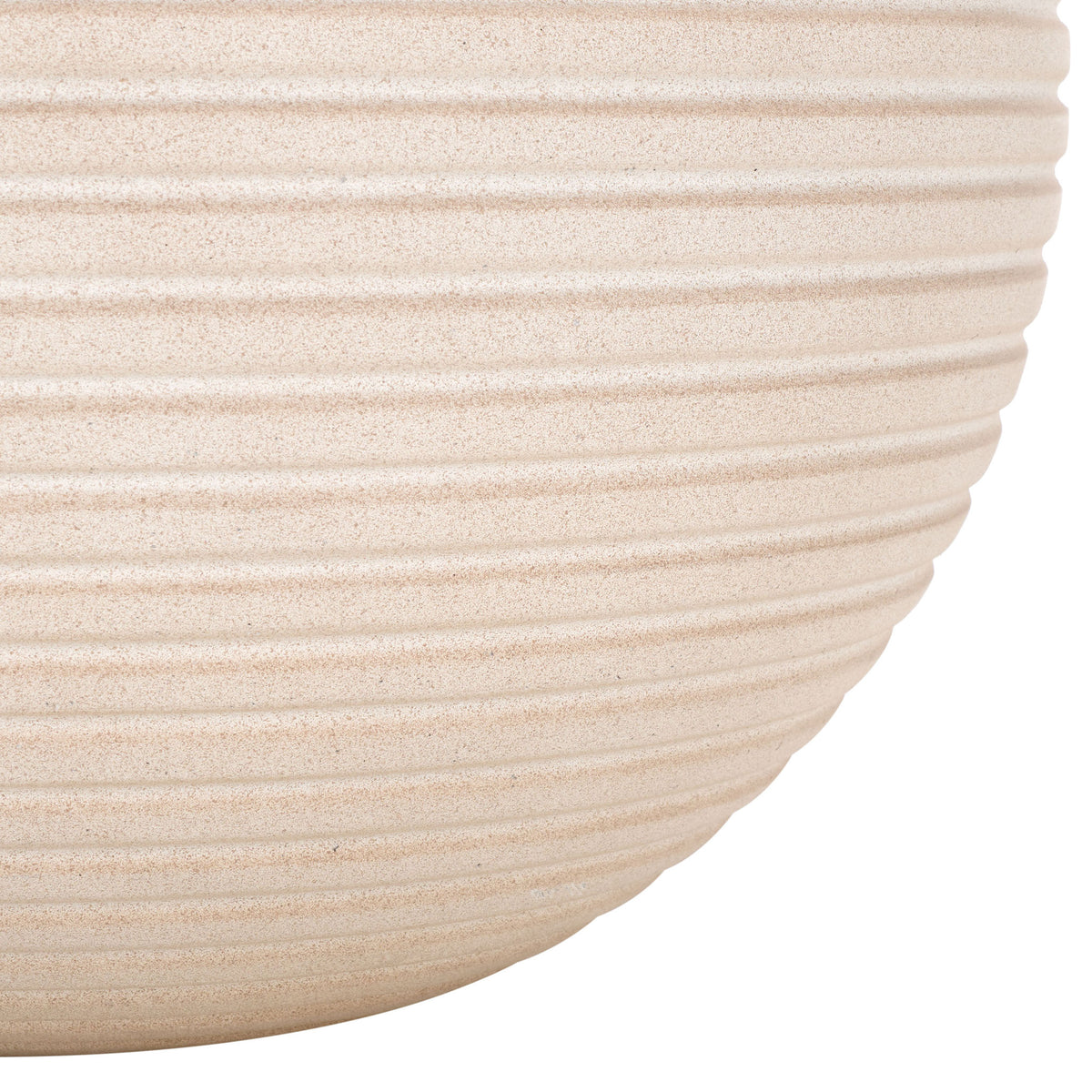 The beige planter's ribbed sides sweep inward to a gently rounded base.