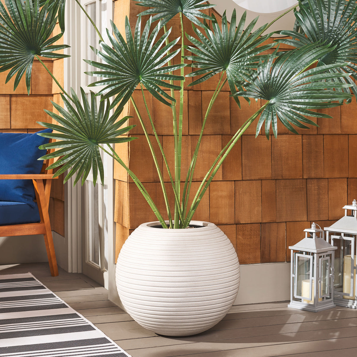 Beige ribbed planter complements fan-shaped foliage with a warm, organic look. || PAT1534B || front_room