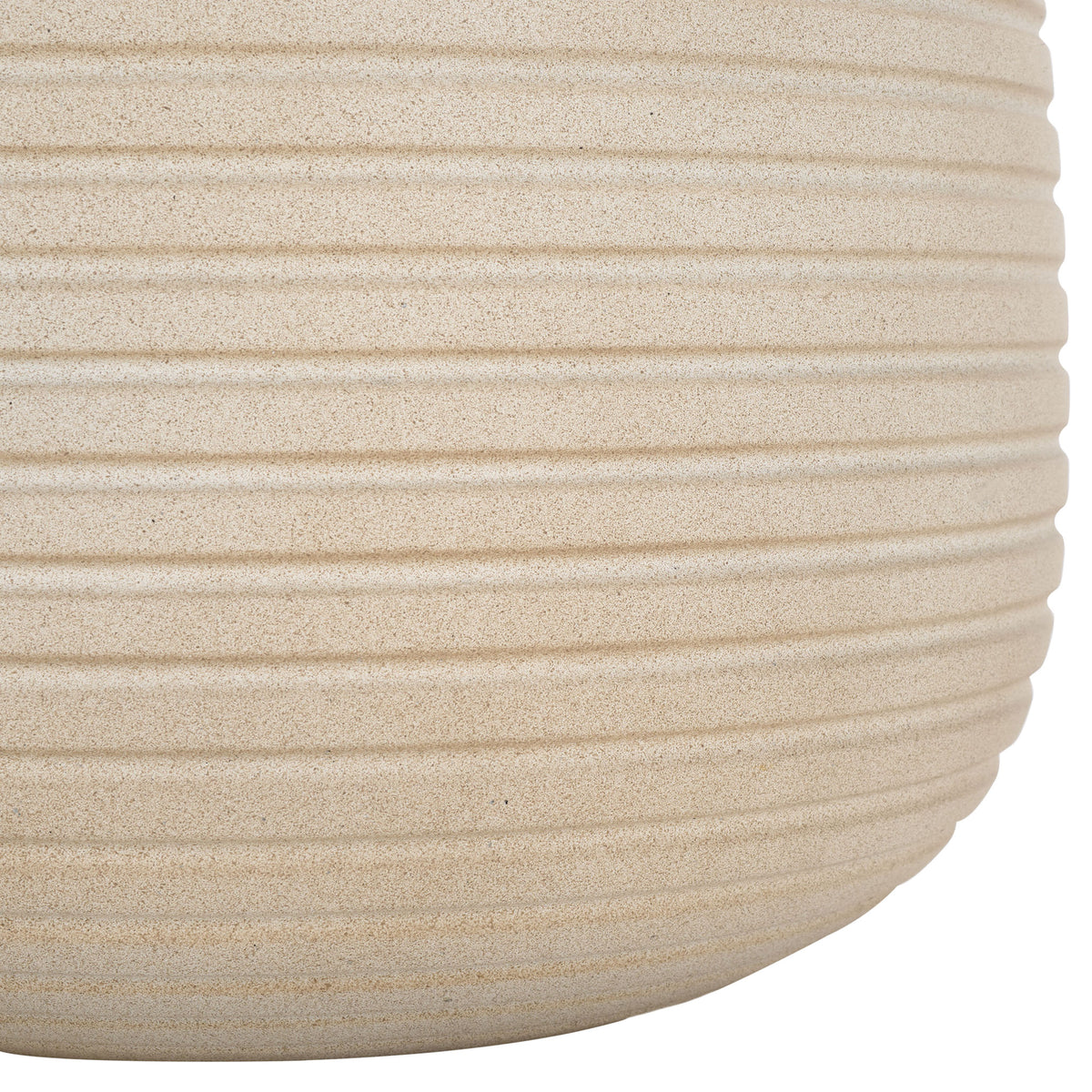 Horizontal ridges continue down the beige planter's curved base