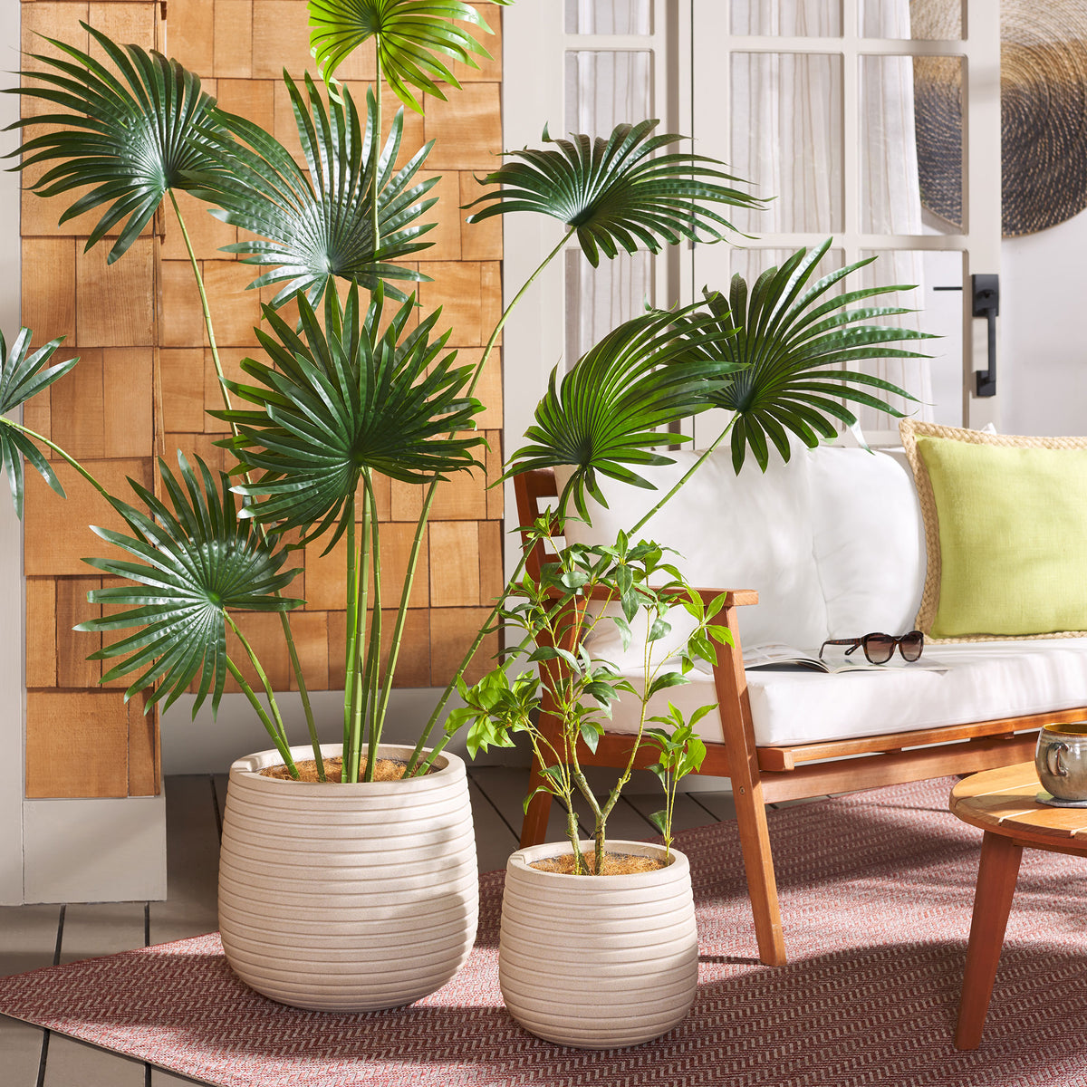 Ribbed beige planters bring greenery and soft texture to a seating area