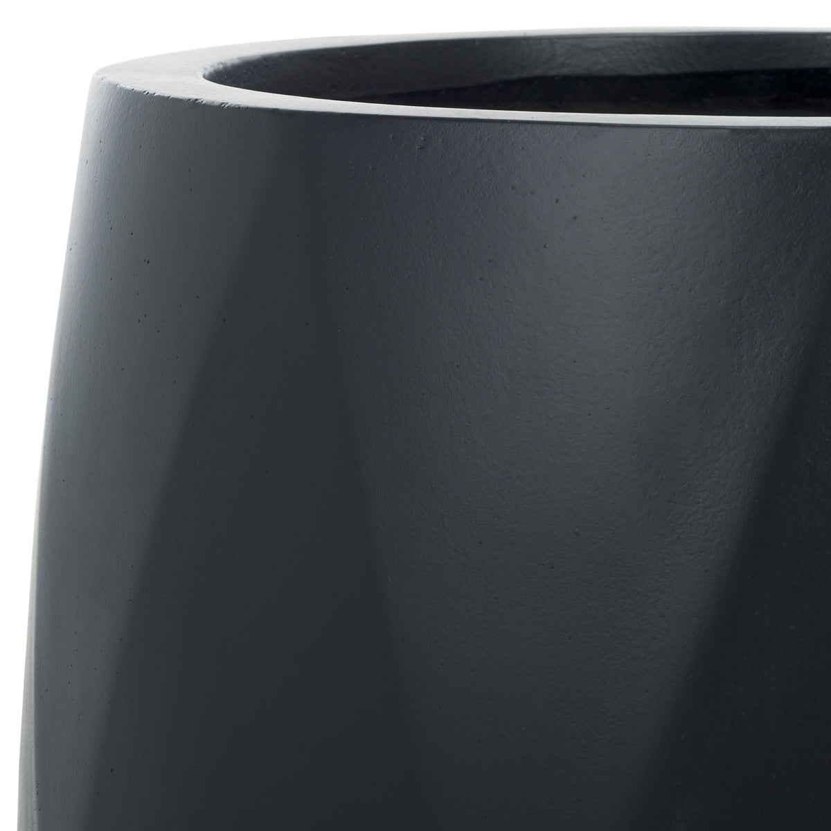 A sleek black rim and subtle angular facets give the planter a modern look.