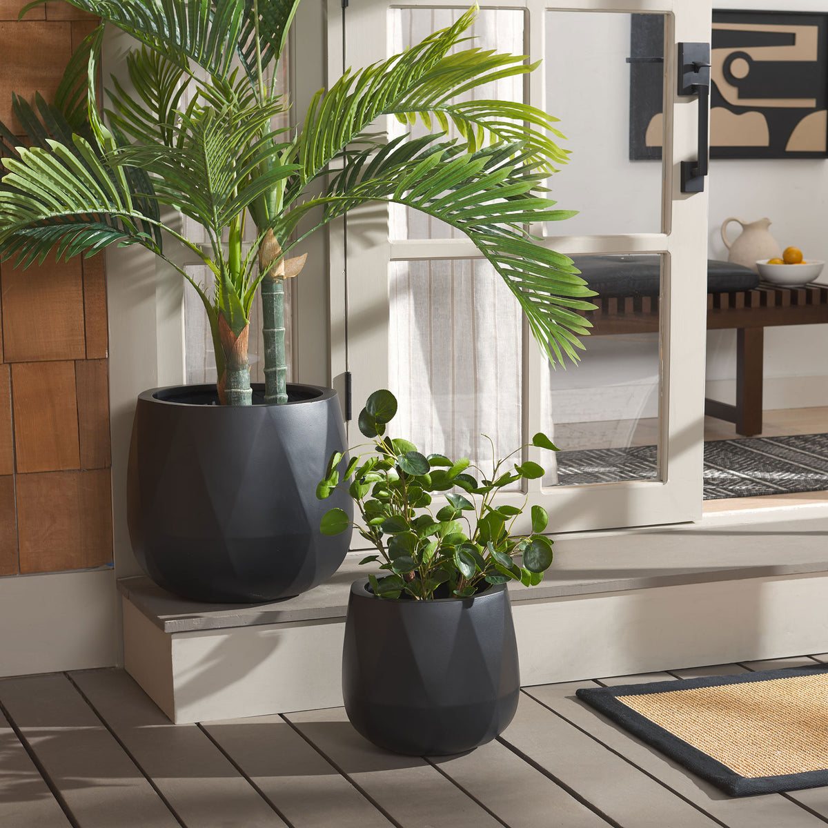 Black planters bring dramatic contrast to tropical foliage by a patio door. || PAT1536A-SET2 || front_room