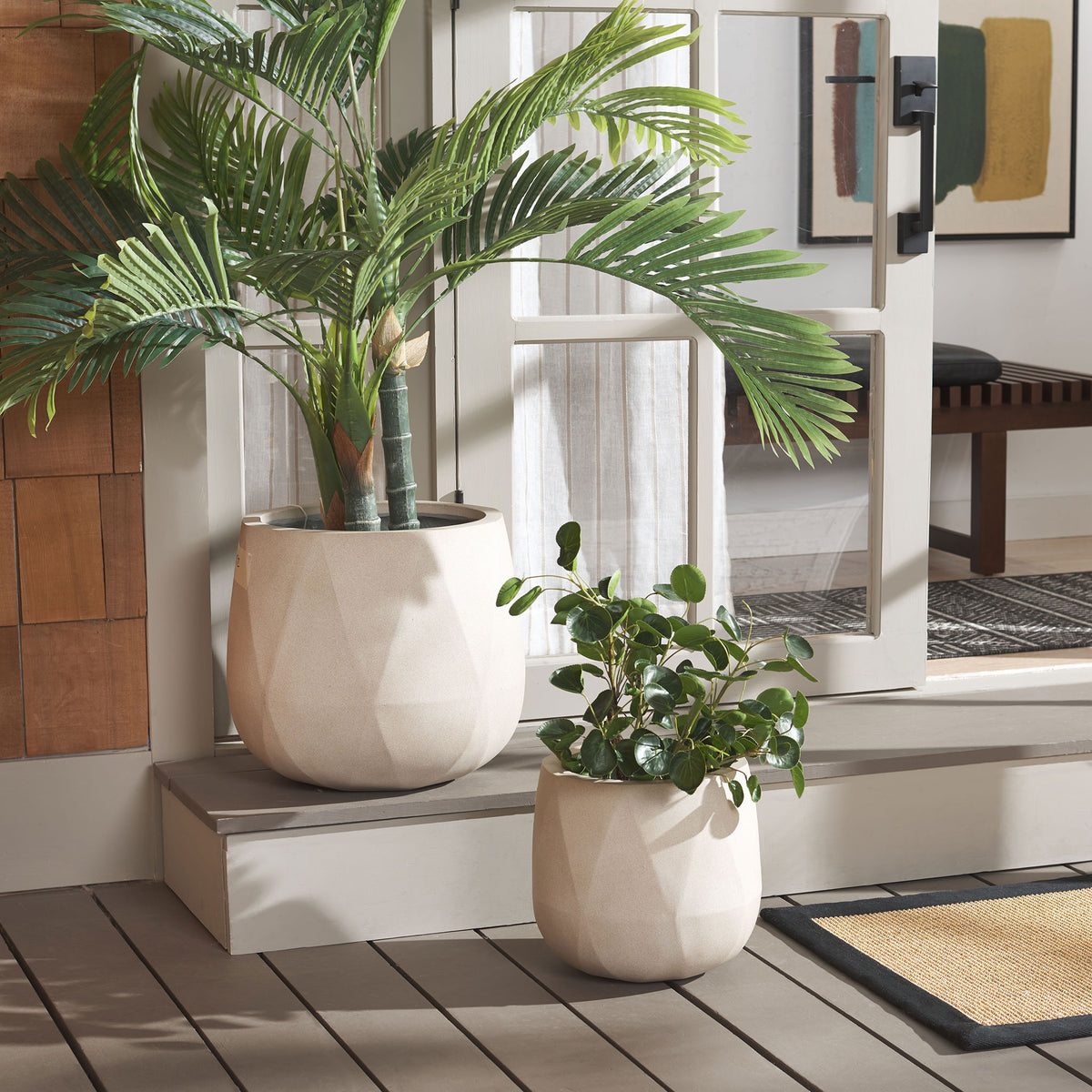 Two beige planters display leafy greenery by a patio door. || PAT1536B-SET2 || front_room