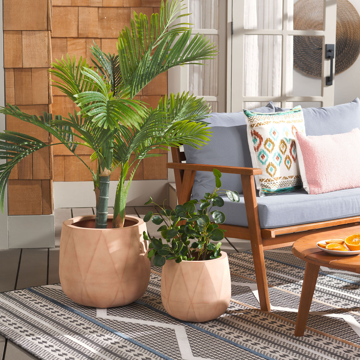 Two diamond-patterned terracotta planters bring warm color to a leafy patio setting. || PAT1536D-SET2 || front_room