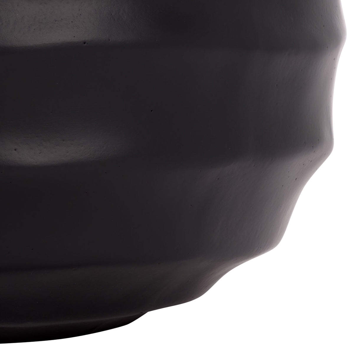 A gently tapered base finishes the black planter's rippled silhouette.