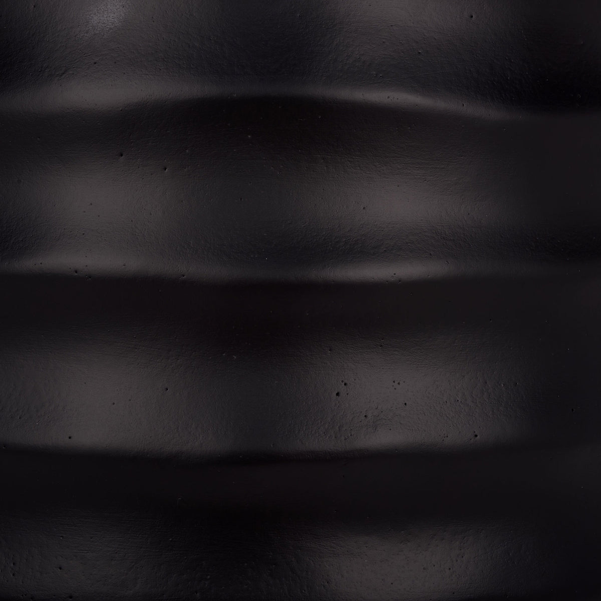 The deep black finish has a subtle sheen across sculpted horizontal ridges. || PAT1542A || swatch_studio