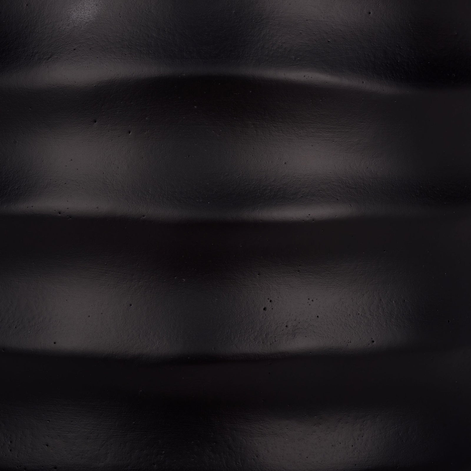 The deep black finish has a subtle sheen across sculpted horizontal ridges. || PAT1542A || swatch_studio