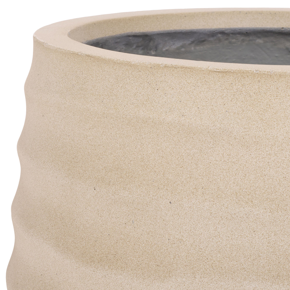 A finely textured beige finish softens the planter's sculpted ridges.