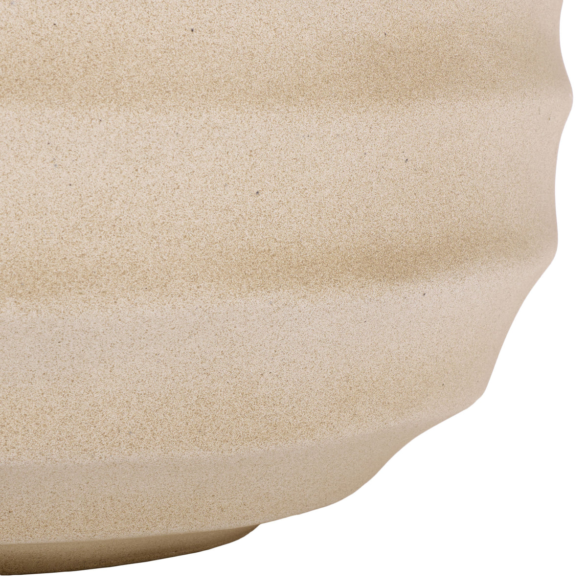 The beige planter's rippled sides taper toward a gently curved base.