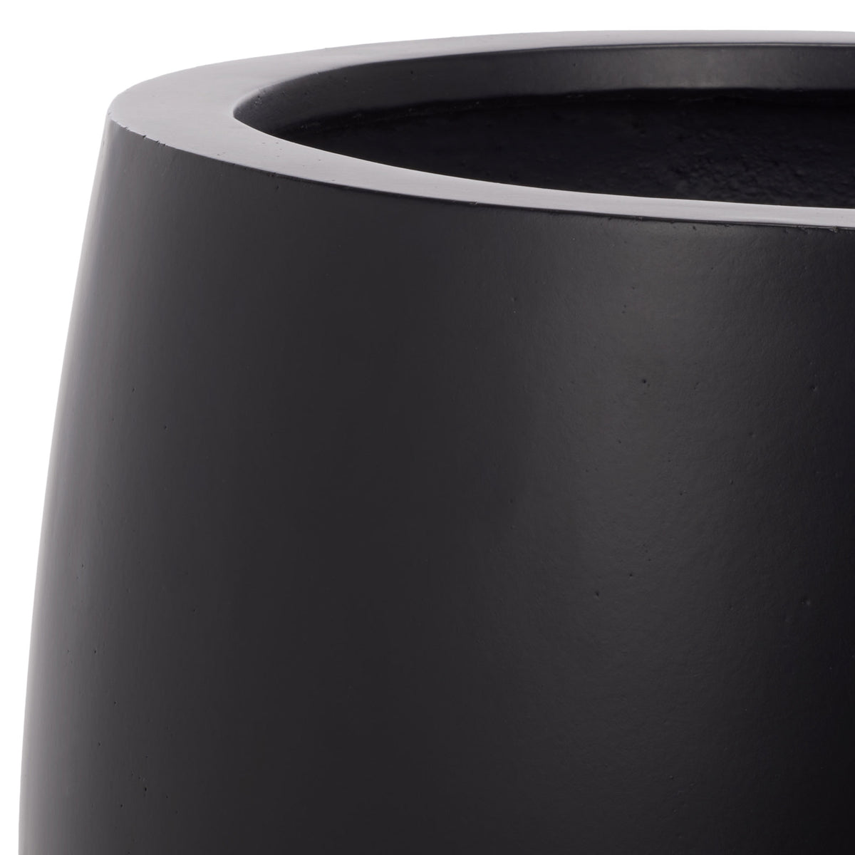 A thick rounded rim meets the smooth black surface of the planter's curved bowl || PAT1545A || detail_studio