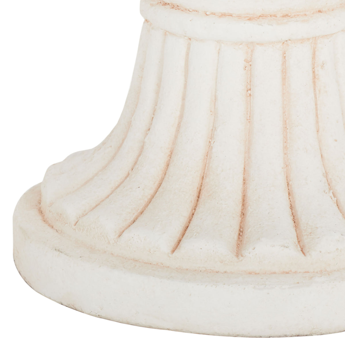 A gently fluted pedestal meets a broad, round base with subtle warm-toned distressing.