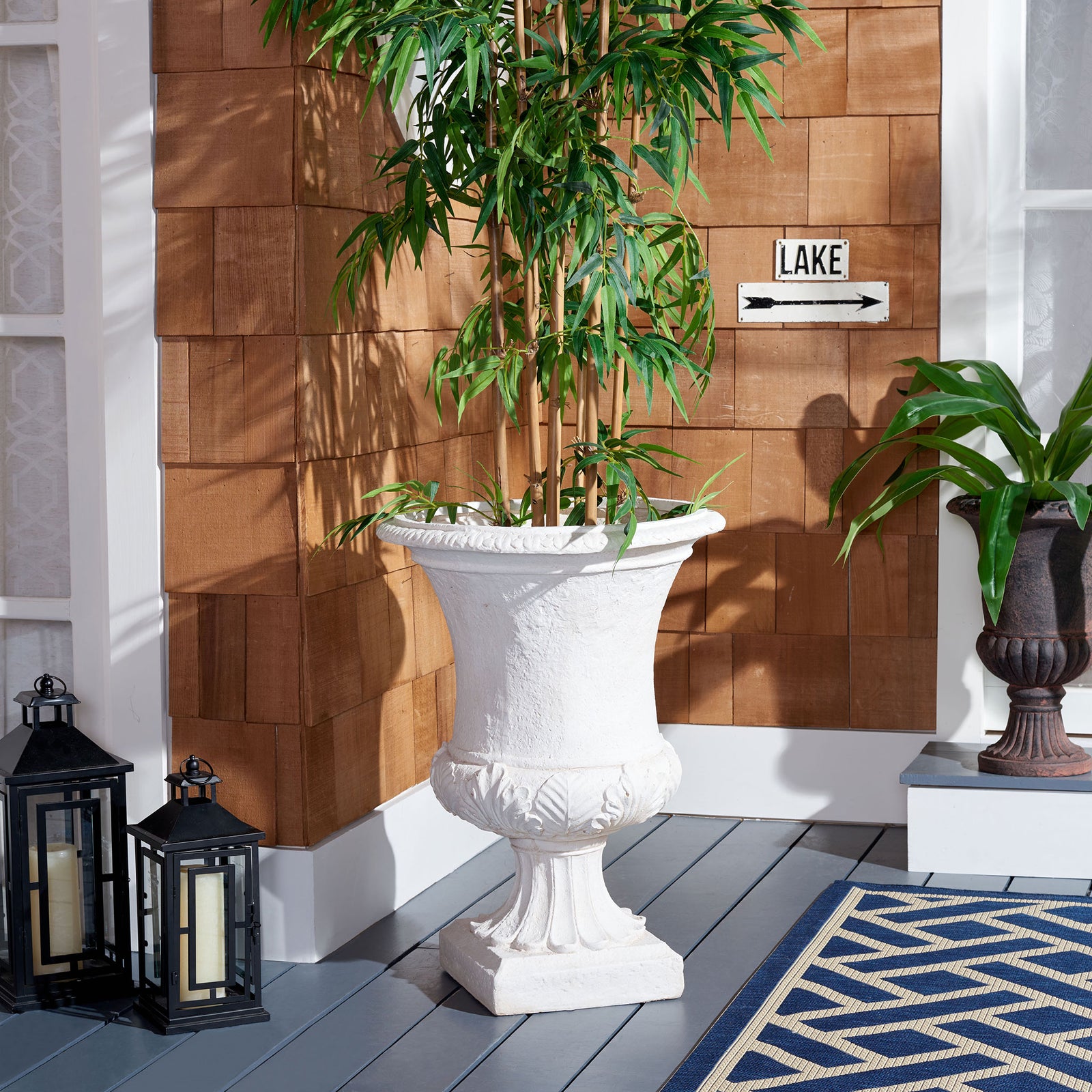 The off-white urn planter lifts leafy greenery on a porch, adding classical detail to the space. || PAT5038A || front_room