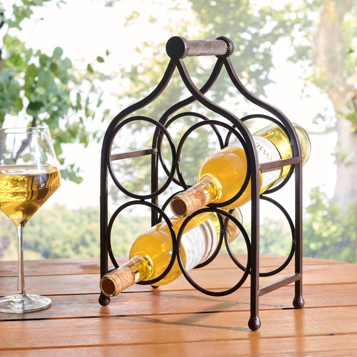 Brown iron wine holder displays bottles neatly on a patio tabletop. || PAT5041B || front_angle_room