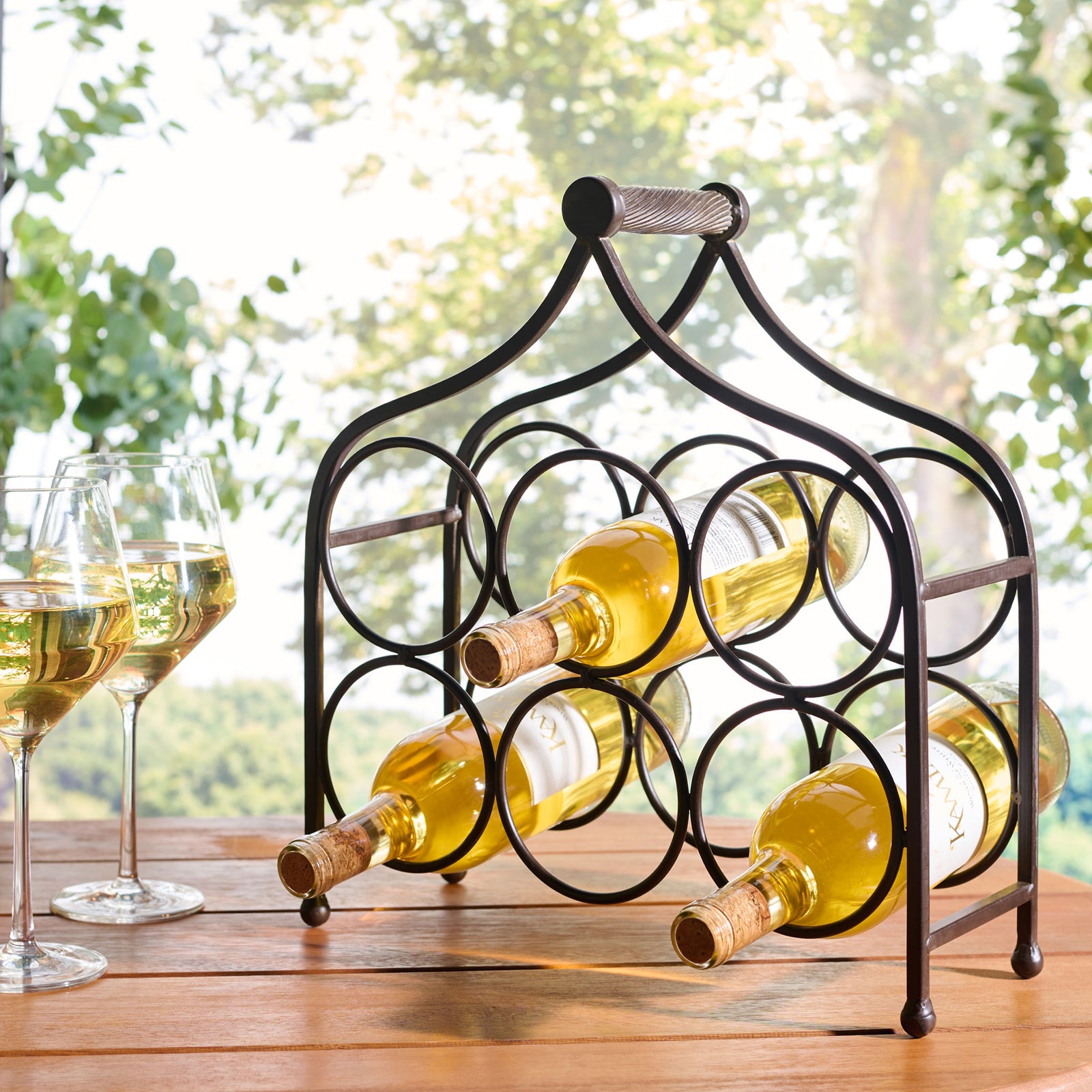 A brown iron rack keeps six wine bottle spaces ready for outdoor entertaining. || PAT5042B || front_angle_room