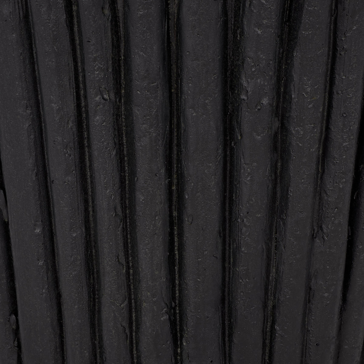 Deep vertical grooves and subtle variations give the black planter its weathered texture || PAT5047E || swatch_studio