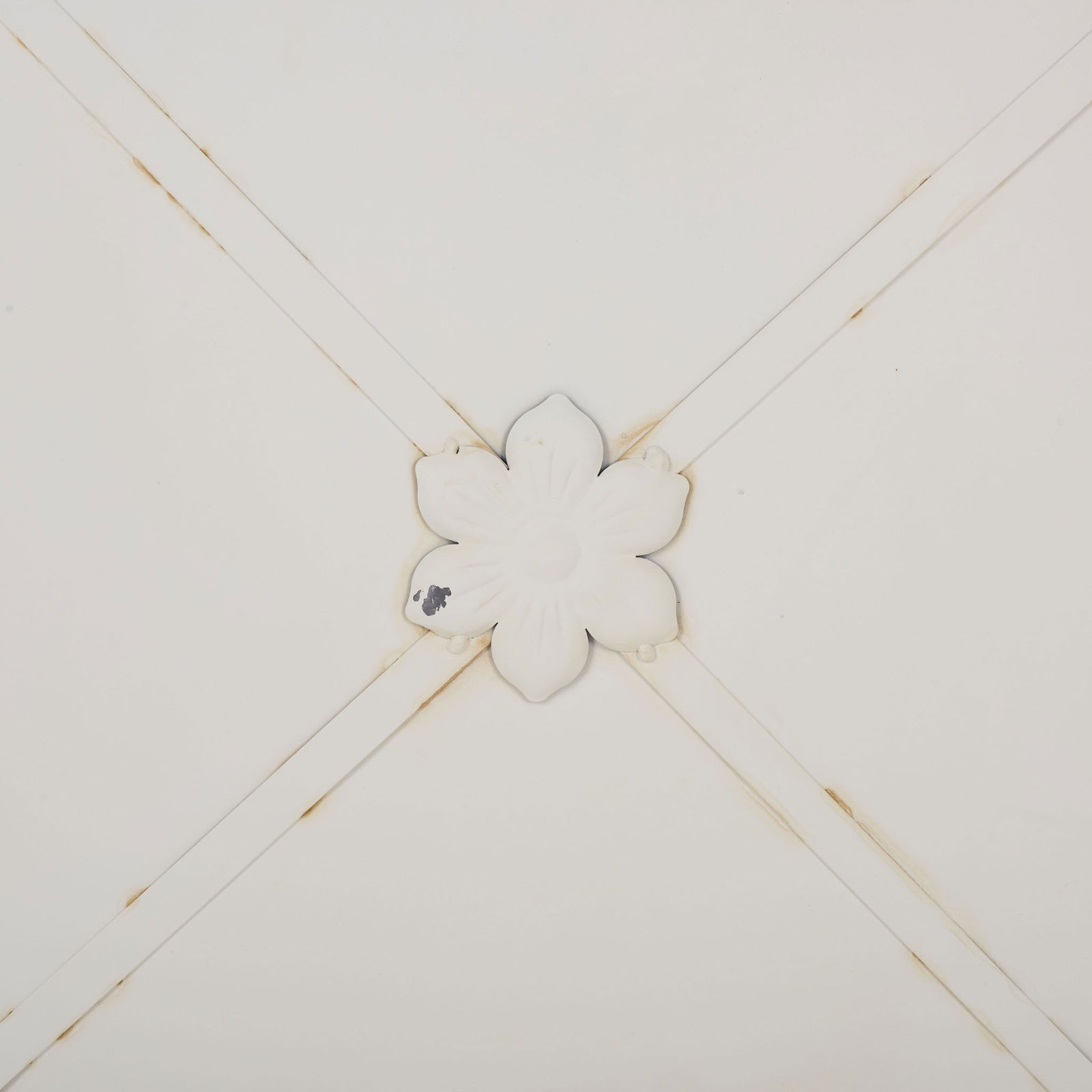 An embossed flower medallion and crossing iron bands add charm to the antique white planter. || PAT5048A || detail_studio