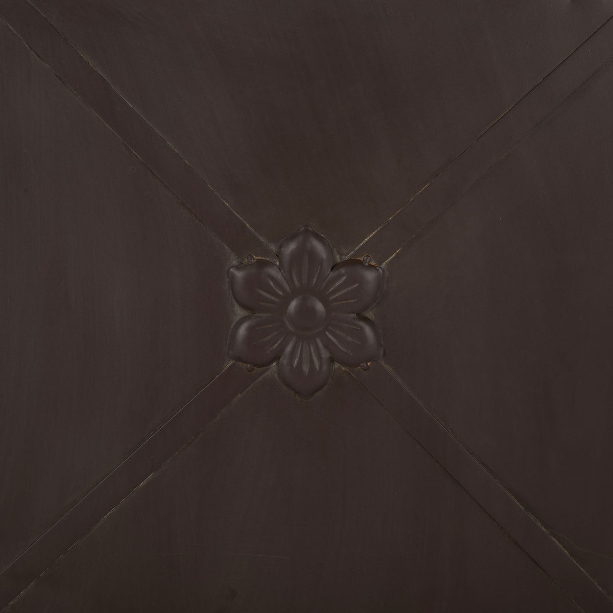 A sculpted flower punctuates the crossed iron bands on the rustic brown planter. || PAT5048B || detail_studio