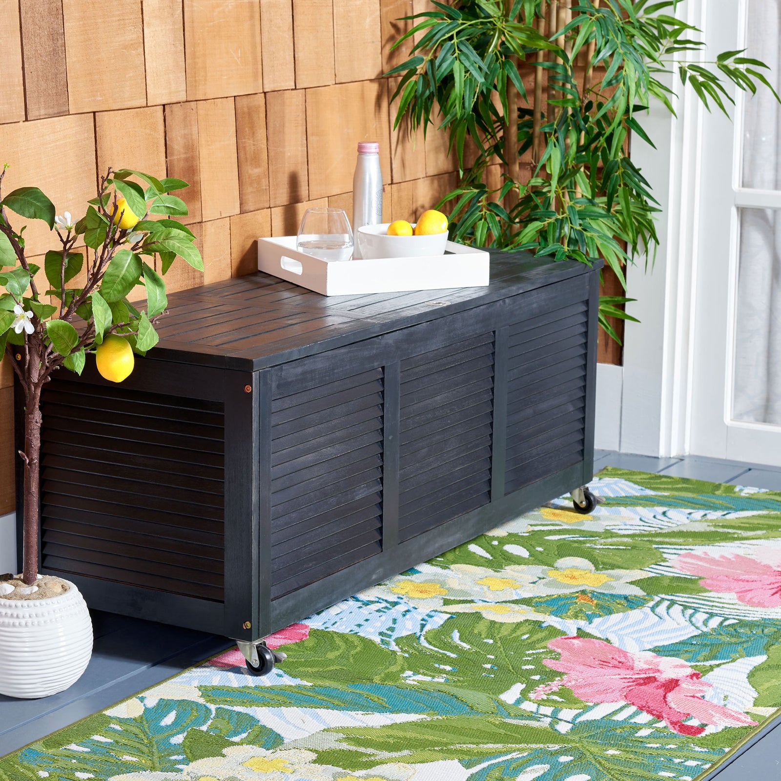 Black louvered wood chest doubles as a convenient surface for outdoor entertaining || PAT7038D || front_angle_room