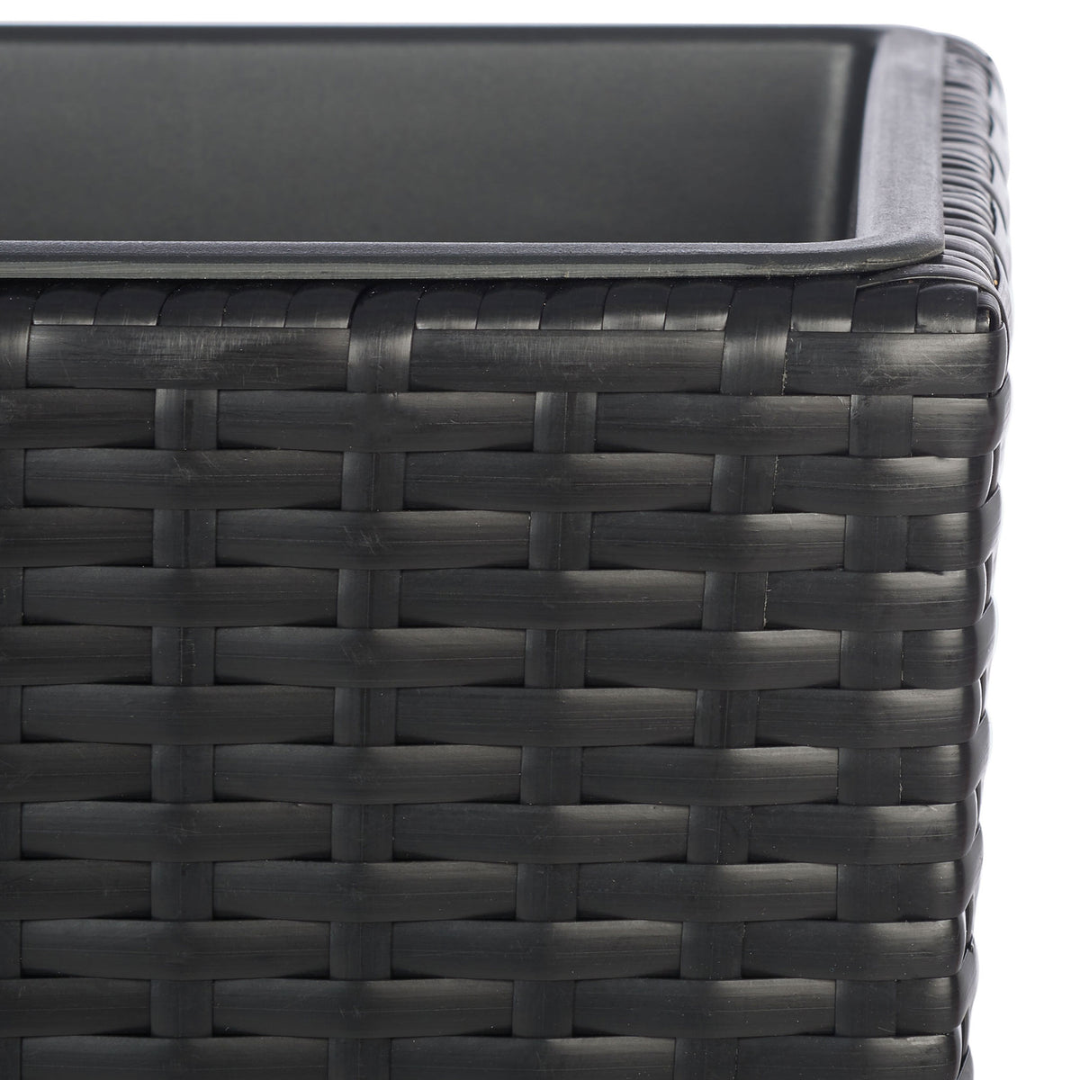 Tightly woven black wicker meets the smooth rim of a planting insert. || PAT7705A || detail_studio