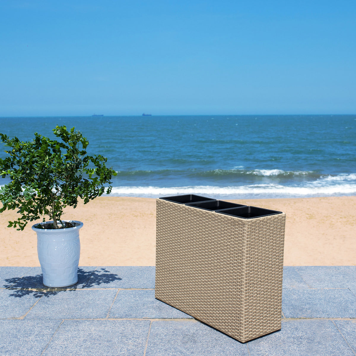 Beige woven planter makes a streamlined home for greenery beside the coast. || PAT7705B || front_angle_room