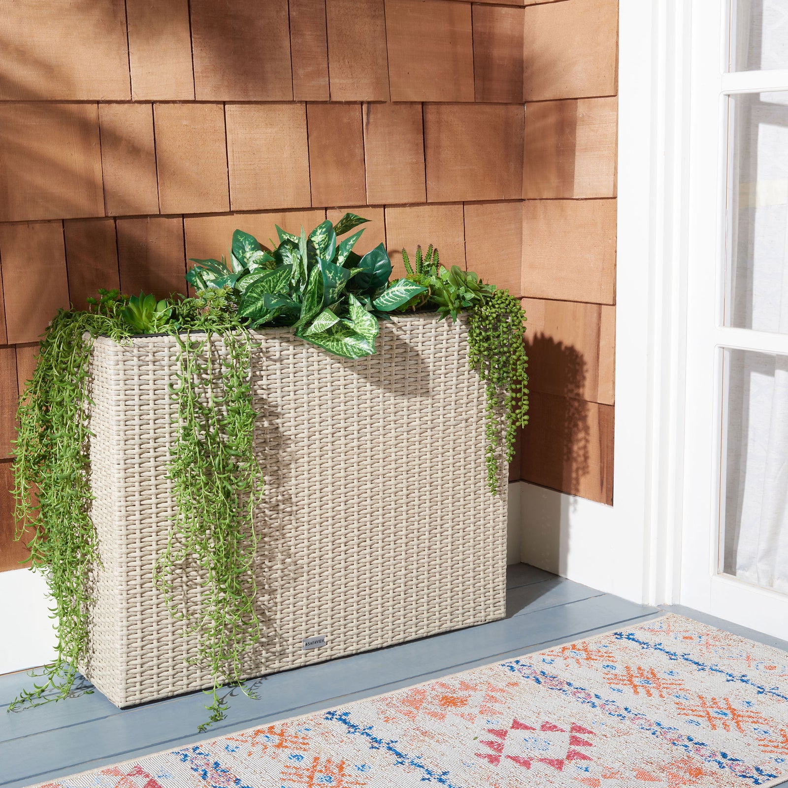 Trailing greenery spills over a beige wicker planter with three roomy inserts. || PAT7705B || back_room