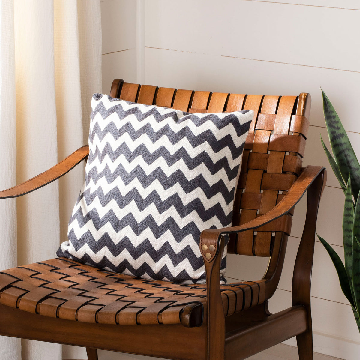 A plush charcoal-and-ivory zigzag pillow adds crisp pattern to a cozy seating nook. || PIL102G-1818 || front_room