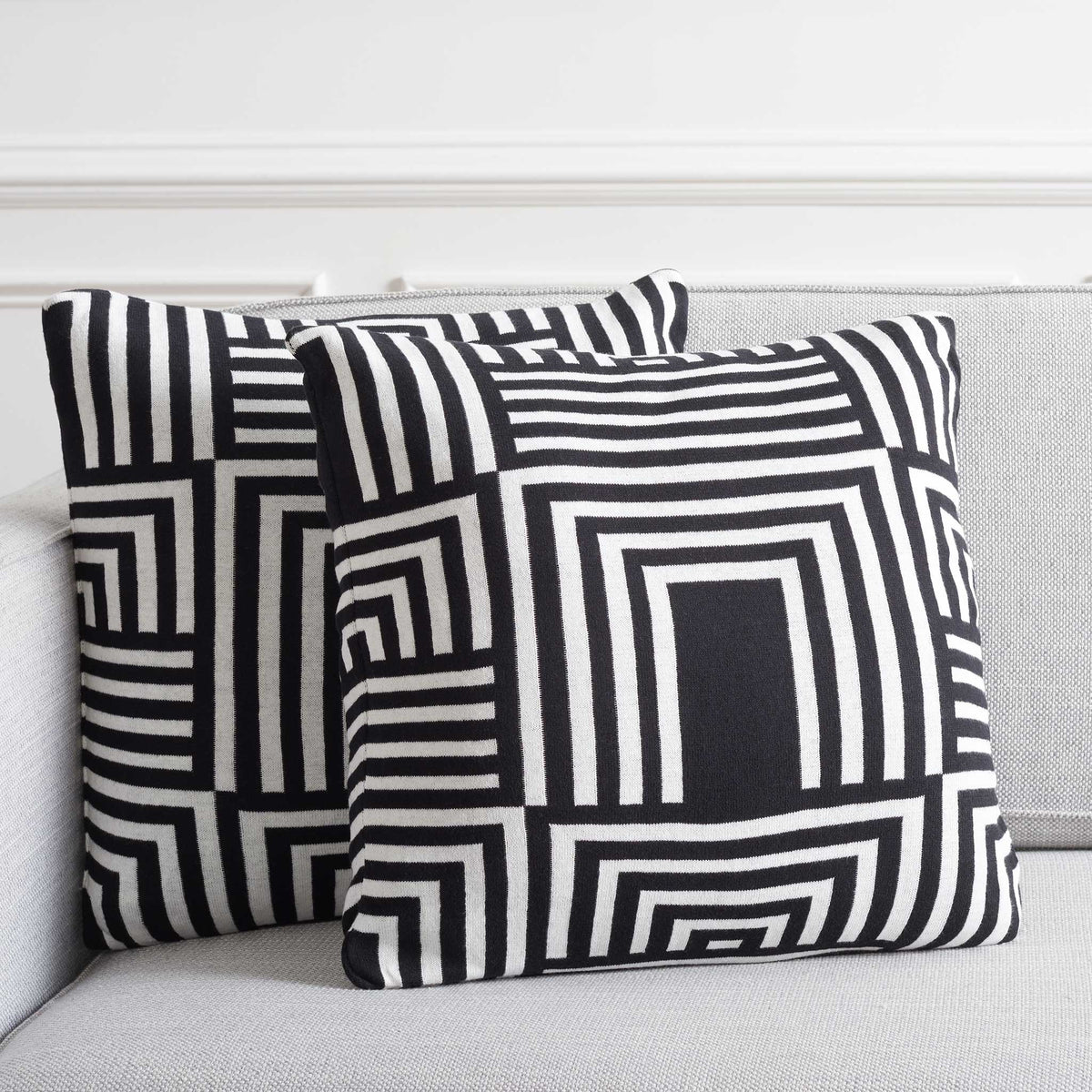 Pair of black-and-ivory geometric pillows brings bold contrast and modern polish to everyday seating || PLS401A-1818-SET2 || front_multi_room