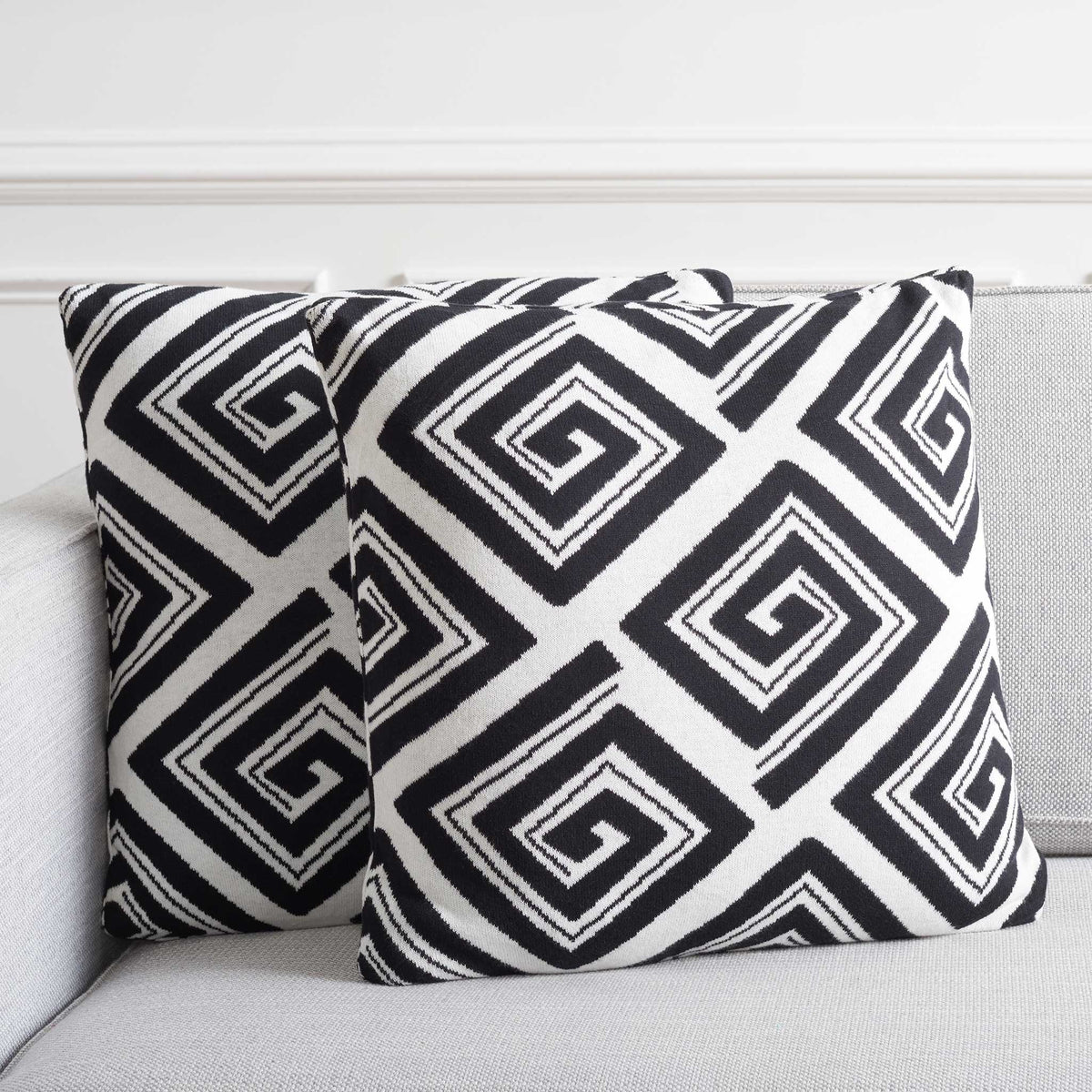 Two graphic black and ivory pillows add crisp contrast on a modern sofa. || PLS403A-1818-SET2 || front_multi_room