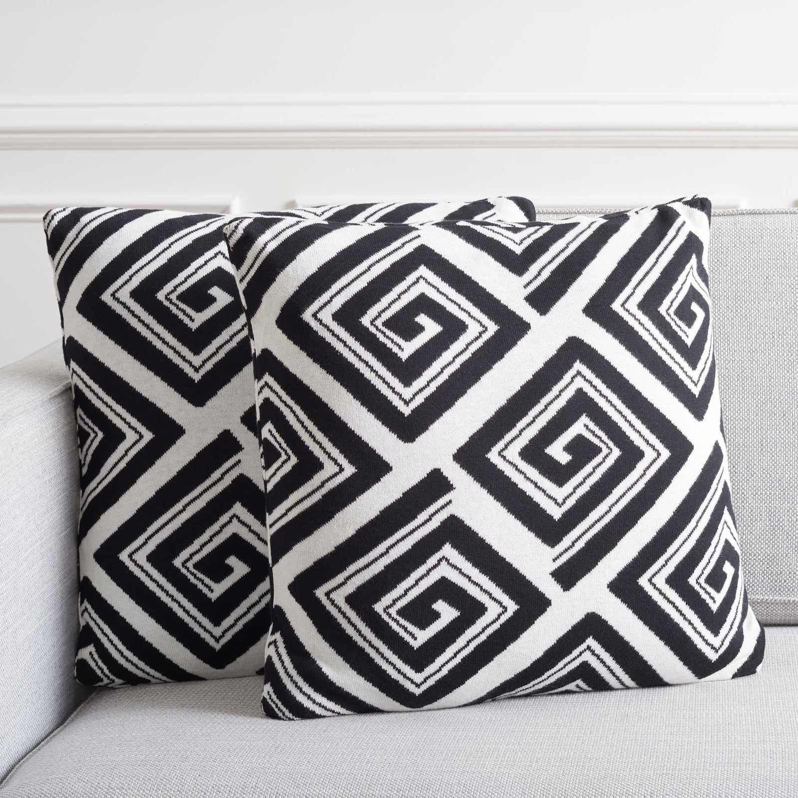 Two graphic black and ivory pillows add crisp contrast on a modern sofa. || PLS403A-1818-SET2 || front_multi_room