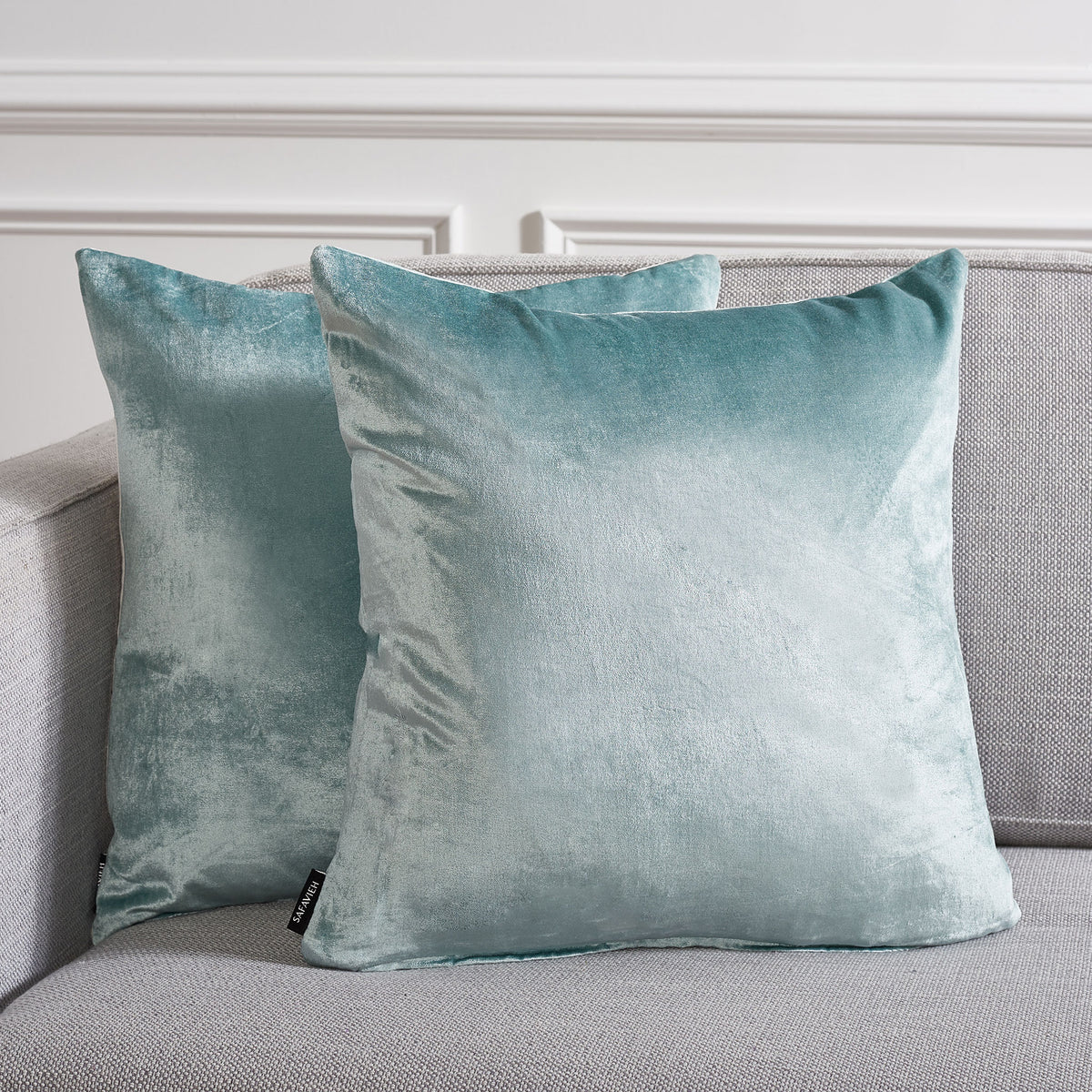 Two plush aqua pillows add a calming splash of color to a neutral sofa. || PLS500B-1818-SET2 || front_multi_room