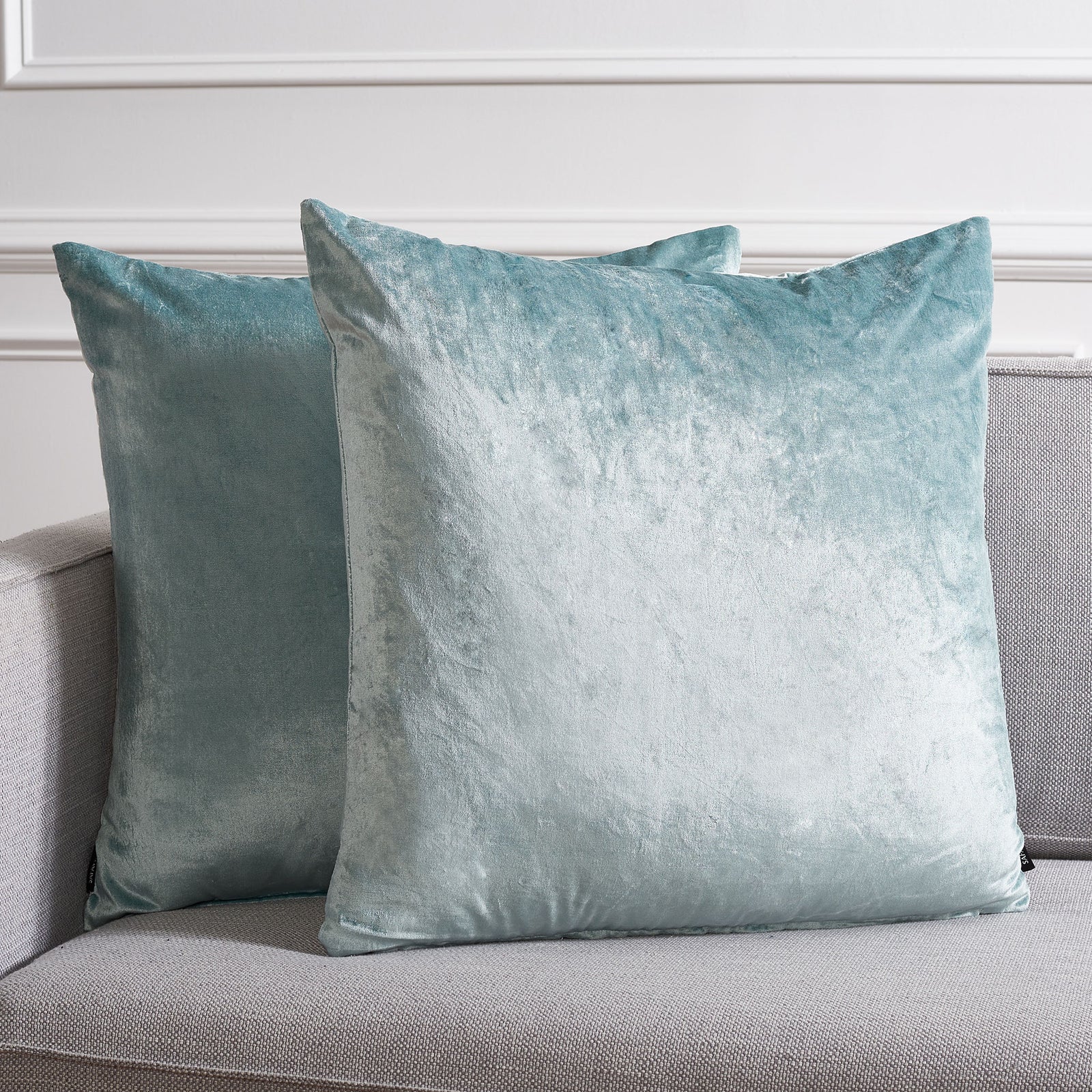 Two roomy aqua pillows brighten a gray sofa with soft color and a velvety glow. || PLS500B-2222-SET2 || front_multi_room