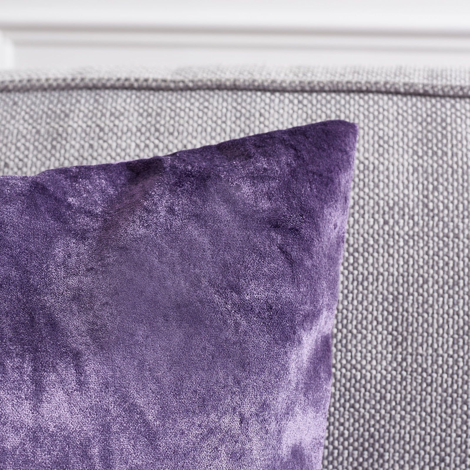 Plush purple fabric catches the light along a gently tapered pillow corner. || PLS500E-1818-SET2 || detail_room
