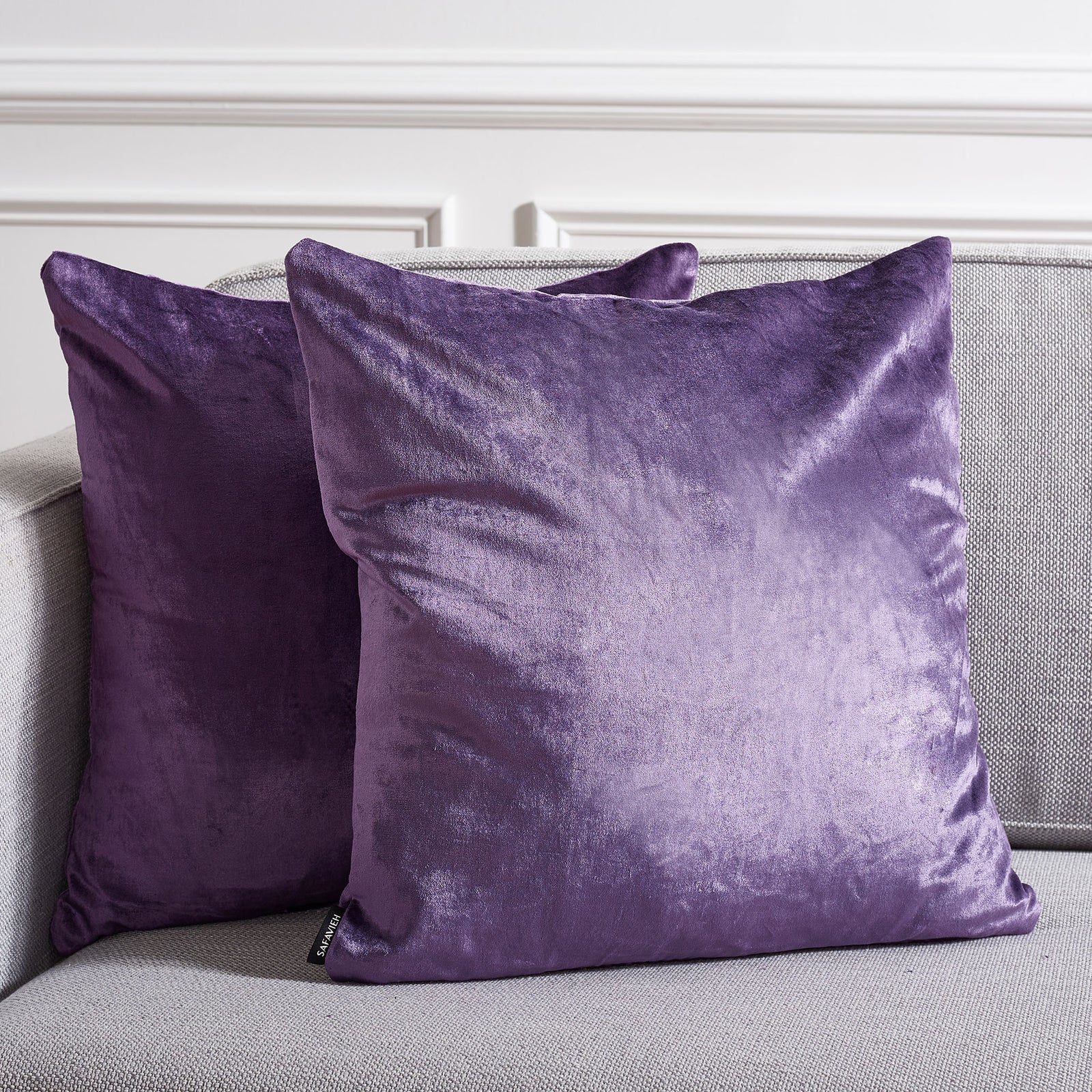 Two rich purple accent pillows warm a neutral sofa with luminous, velvety texture. || PLS500E-1818-SET2 || front_multi_room