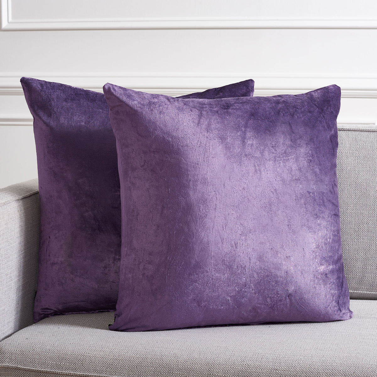 Two generously sized purple pillows bring jewel-toned color and cozy texture to a sofa. || PLS500E-2222-SET2 || front_multi_room