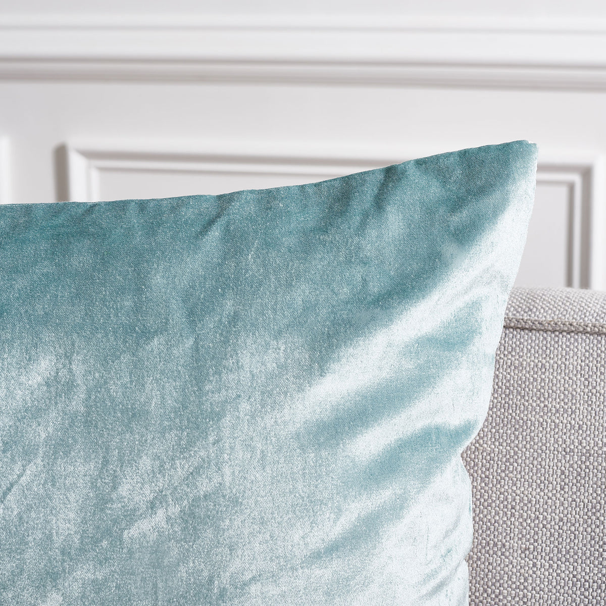 The aqua pillow's plush surface glimmers beside its softly tapered corner || PLS503B-2222-SET2 || detail_room