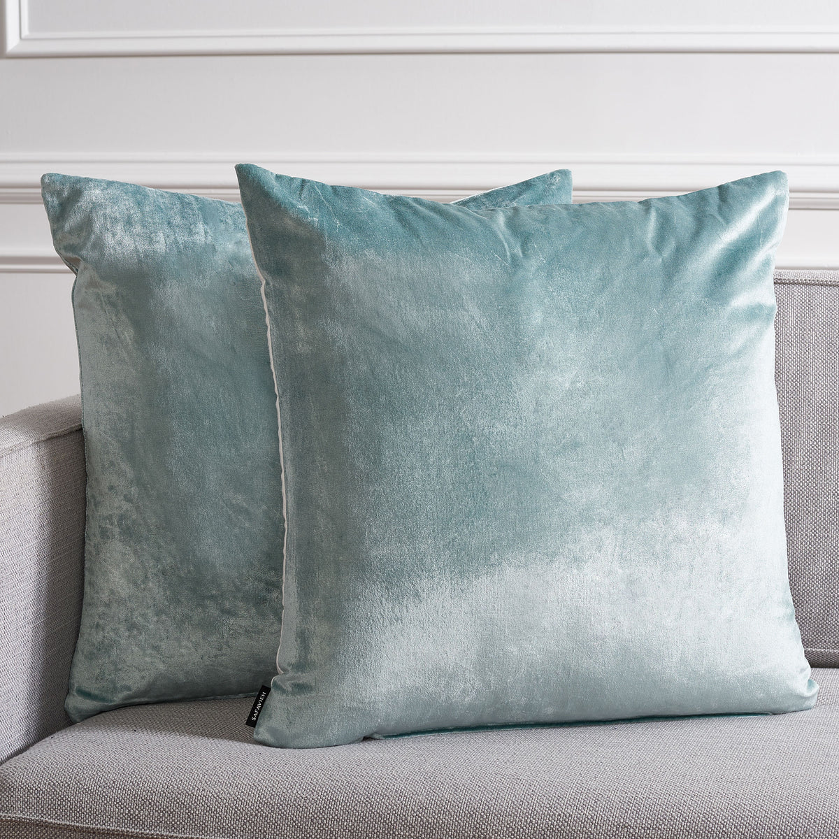 Two large aqua pillows lend a luminous, cool-toned accent to neutral upholstery || PLS503B-2222-SET2 || front_multi_room