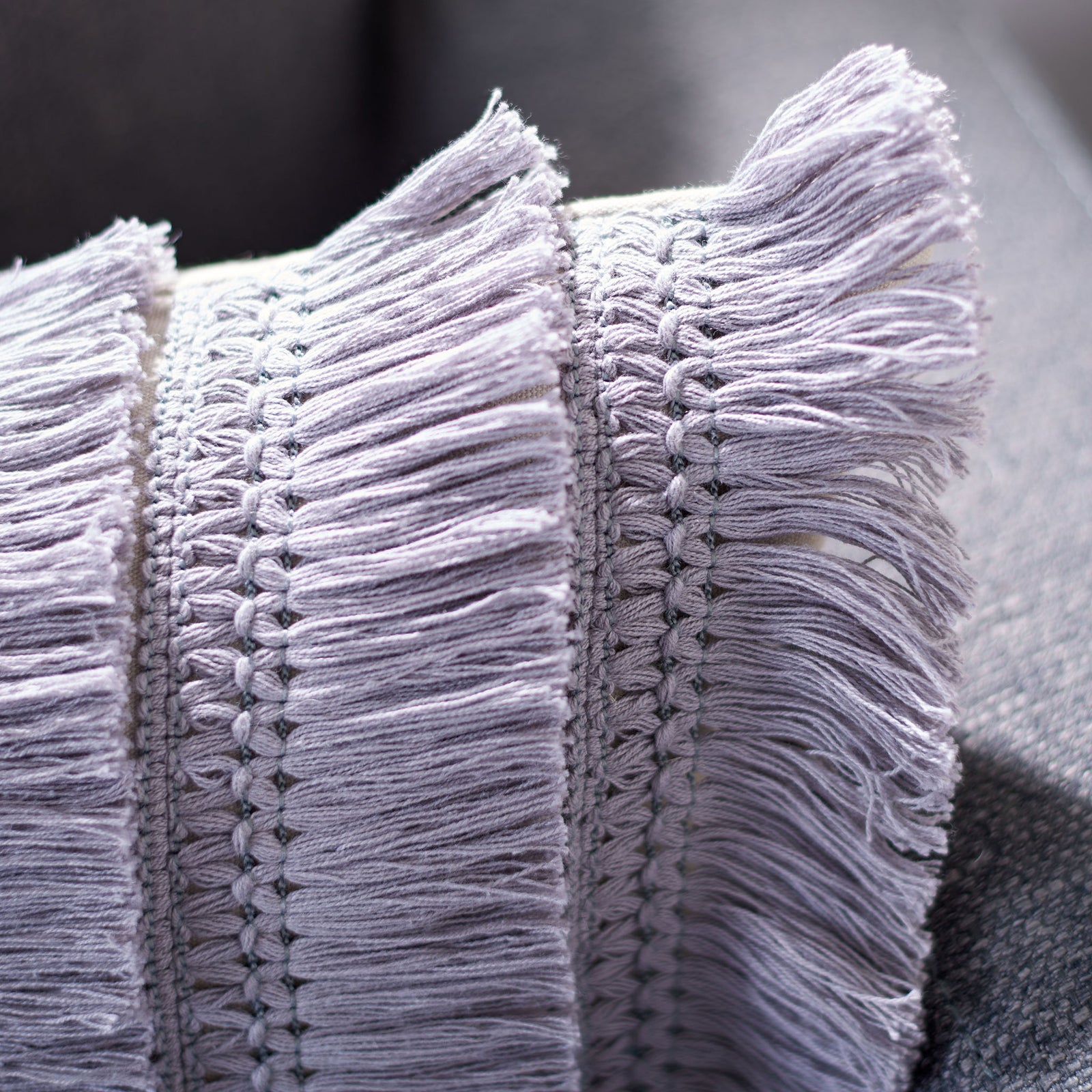 Textured periwinkle bands and long, wispy fringe add tactile depth to this lumbar pillow. || PLS7142F-1220 || detail_room