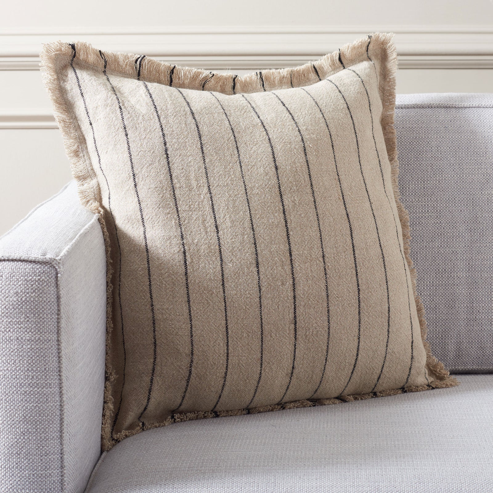 Natural linen pillow with slim black stripes adds relaxed texture to a sofa || PLS8001A-2020 || front_angle_room