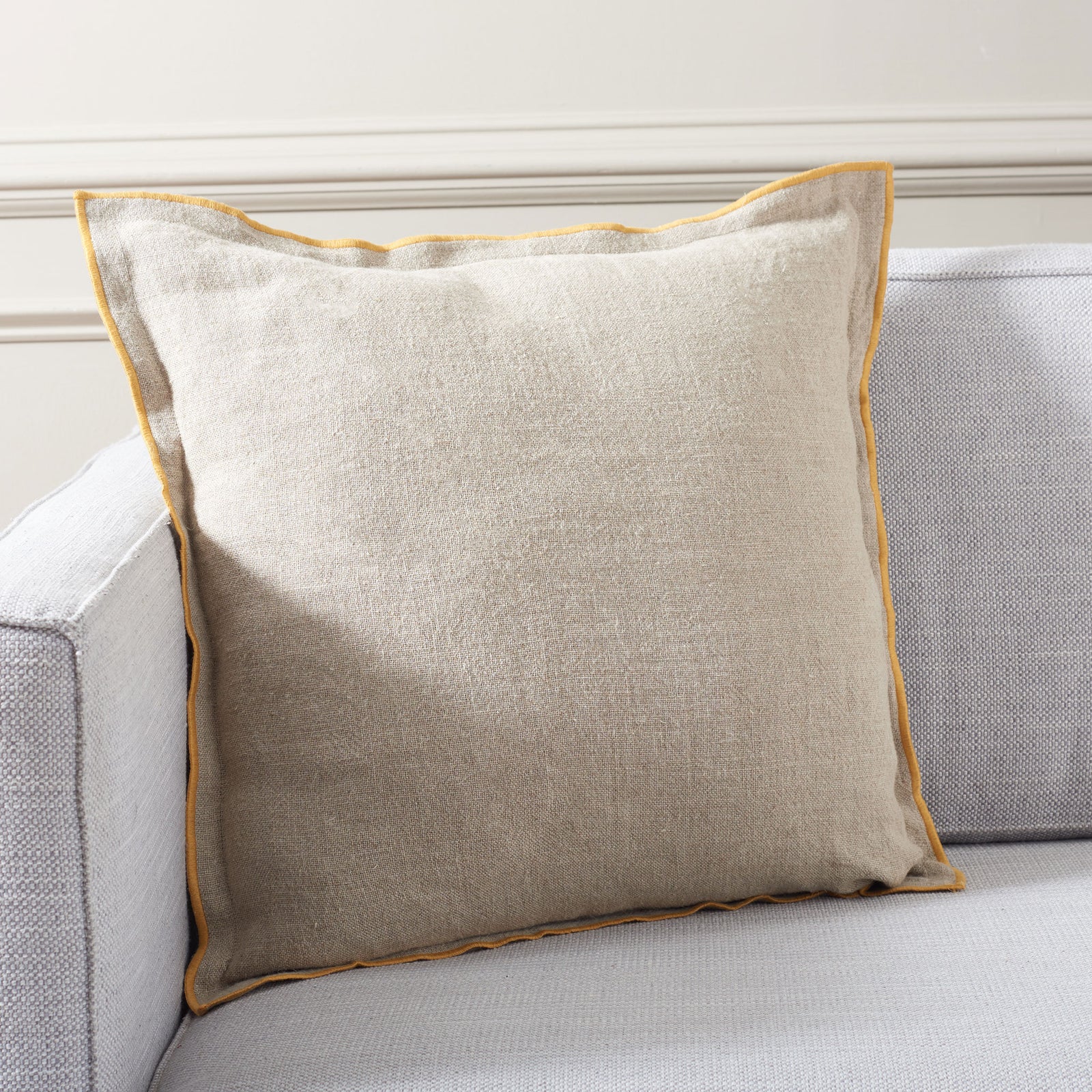 Textured linen pillow with mustard edging adds easy warmth to a neutral sofa || PLS8002A-2020 || front_room
