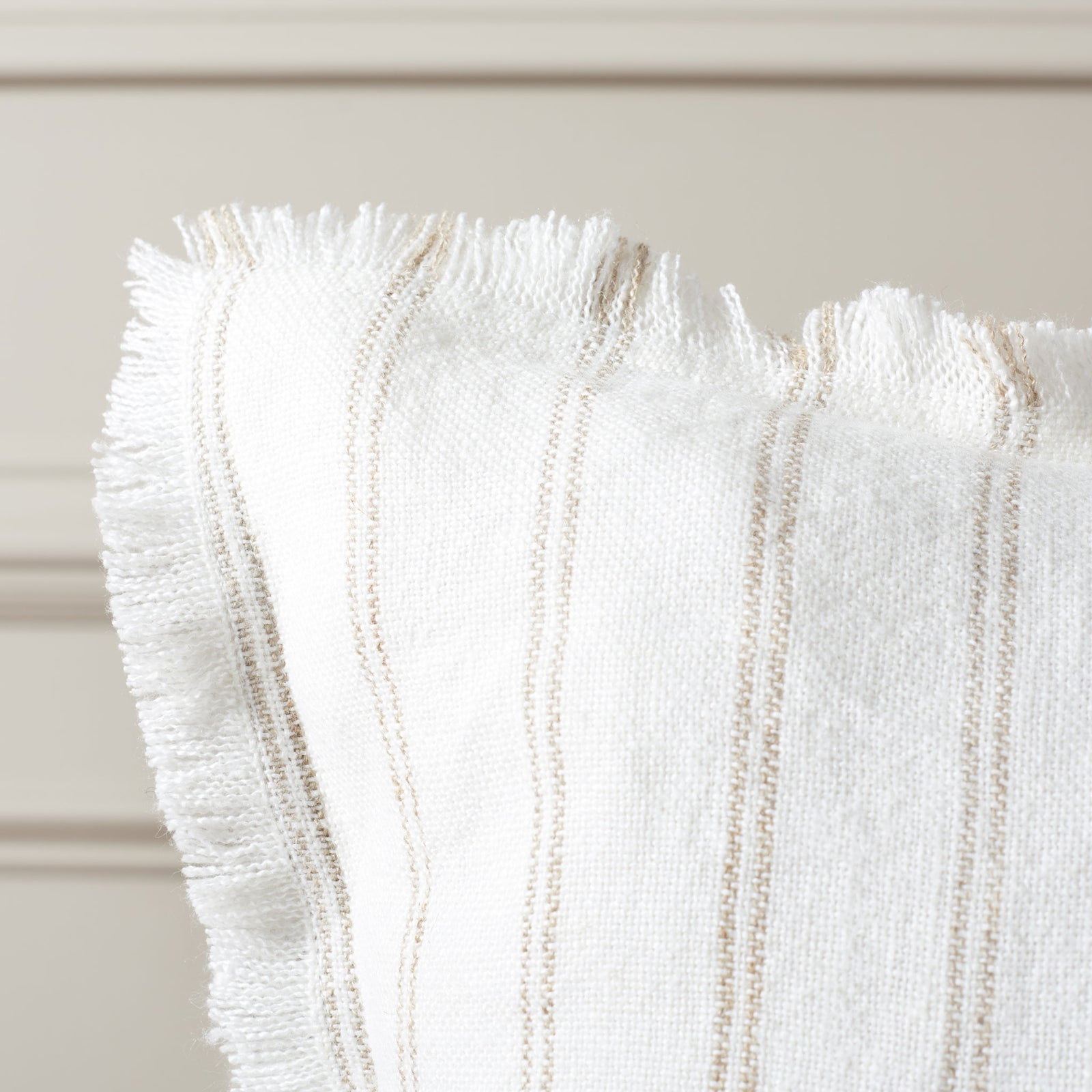 Delicate natural stripes and wispy fringe add texture to this ivory linen pillow || PLS8007A-2020 || corner_room