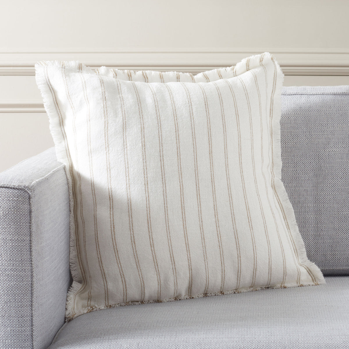 An ivory striped linen pillow brings relaxed texture and comfort to a sofa || PLS8007A-2020 || front_angle_room