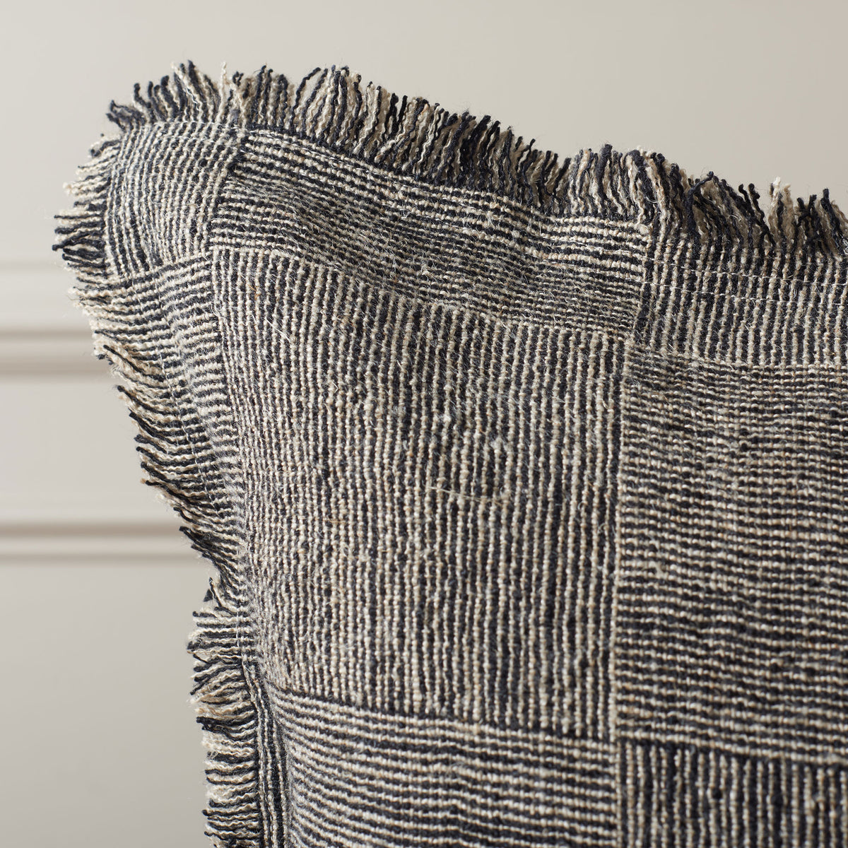 Fringed edges soften the pillow's tightly woven black-and-natural pattern. || PLS8008A-2020 || detail_room