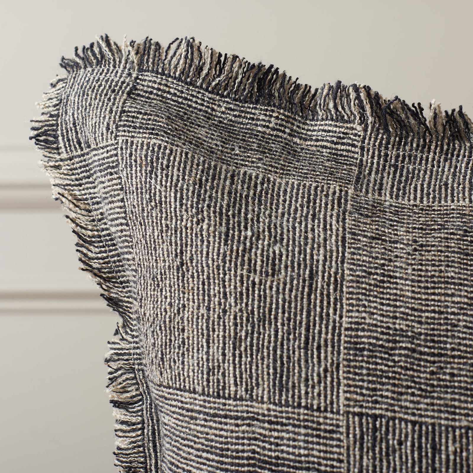 Fringed edges soften the pillow's tightly woven black-and-natural pattern. || PLS8008A-2020 || detail_room