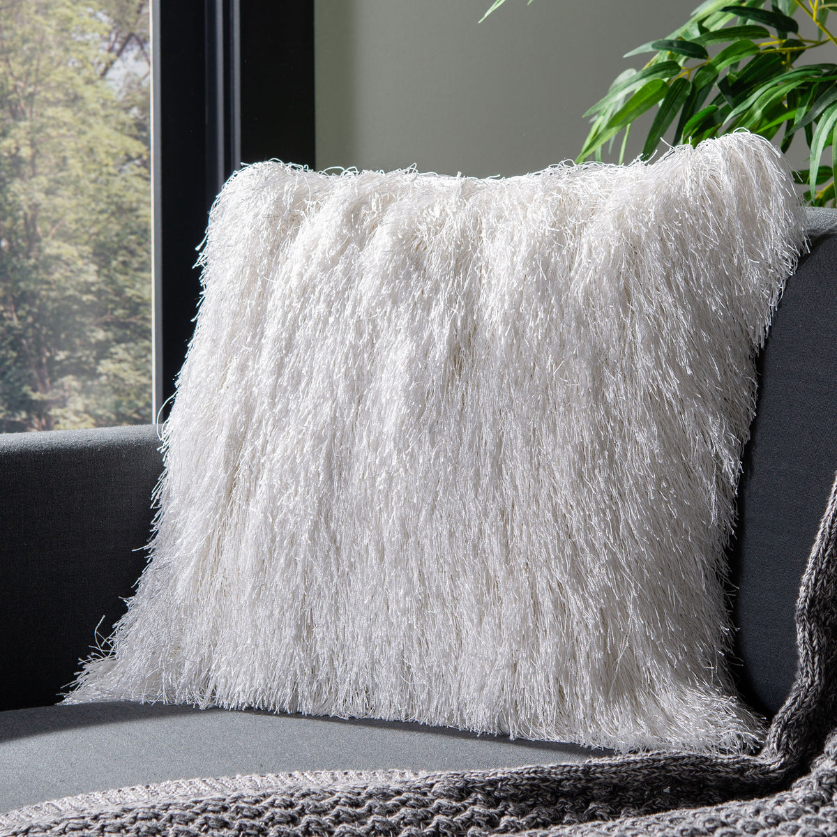 A pearl shag pillow adds cozy texture to a charcoal sofa || PPL210A-2020 || front_room
