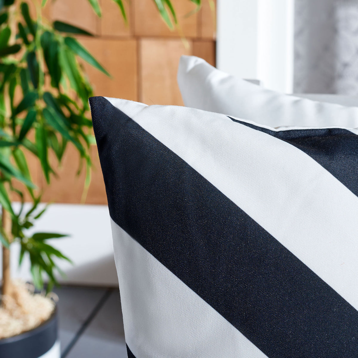 Black and white diagonal stripes reveal the pillow's subtly textured fabric. || PPL262B-1818 || detail_room