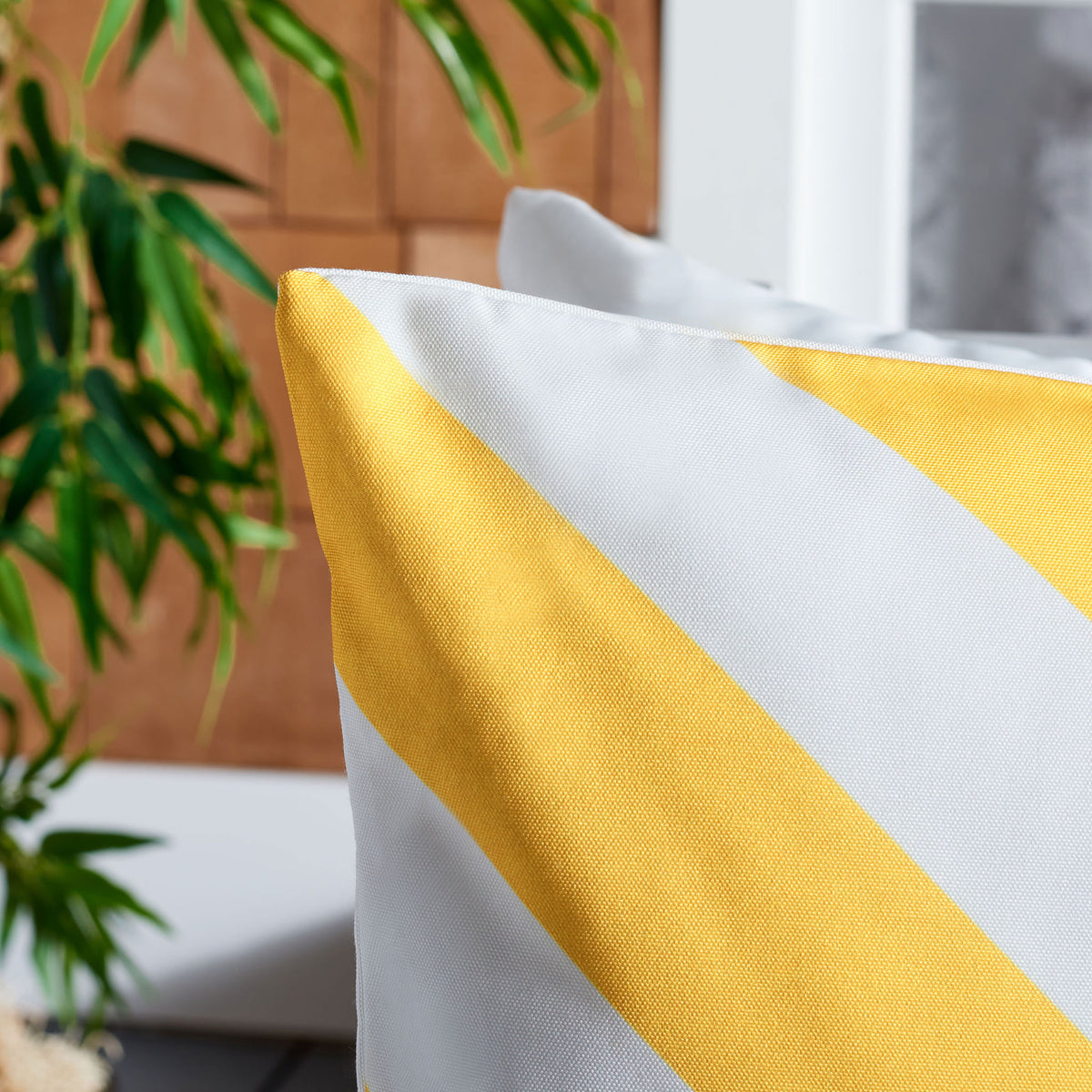 Sunny yellow and white diagonal bands reveal the pillow's fine fabric weave. || PPL262E-1818 || detail_room